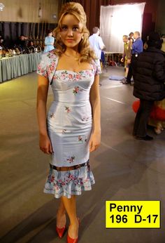 a woman in a dress and red shoes posing for the camera