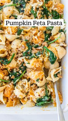 a casserole dish filled with pasta and spinach