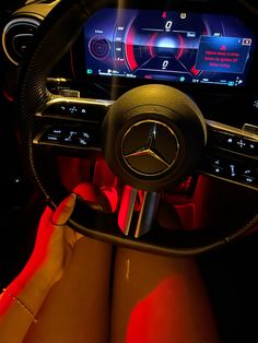 a woman is sitting in the driver's seat of a car with her feet on the steering wheel