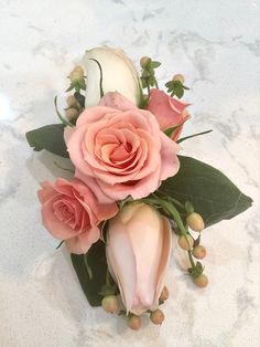 pink and white flowers are arranged on a marble surface