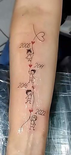 a person with a tattoo on their arm that has the names of two people in it