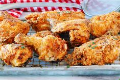 fried chicken on a cooling rack with a red and white checkered cloth in the background