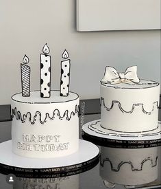 two birthday cakes sitting on top of each other