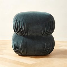 two green cushions sitting on top of a wooden floor