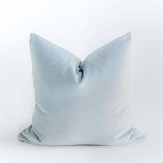 a light blue pillow on a white background