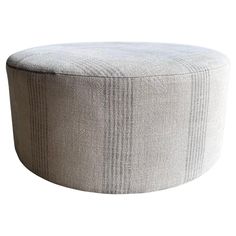 a round ottoman that is made out of fabric