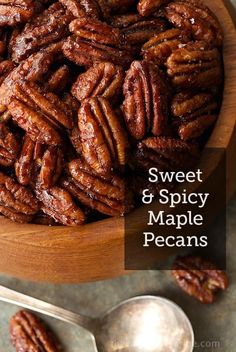 a wooden bowl filled with pecans on top of a table