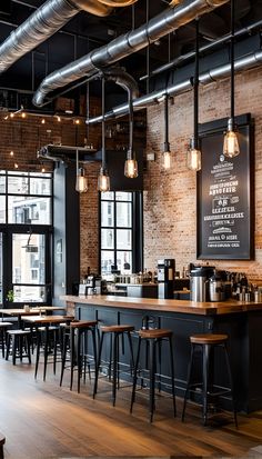 the interior of a restaurant with wooden tables and stools, brick walls, exposed pipes, and industrial lights