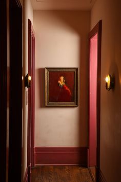 an empty hallway with a painting on the wall