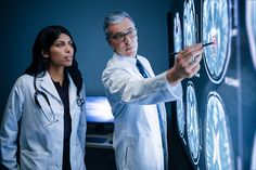 two doctors looking at an image on a wall