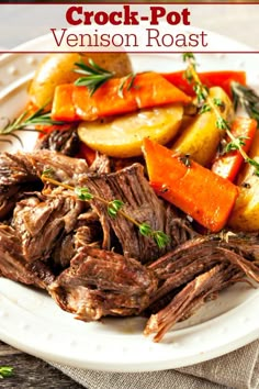 a white plate topped with roast, carrots and potatoes on top of a table