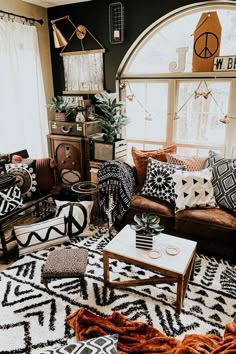 a living room filled with lots of furniture and decor on top of a white rug