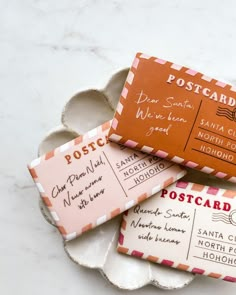 three different types of postcard soaps on a white plate with pink and orange envelopes