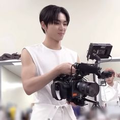 a man holding a video camera in his hands