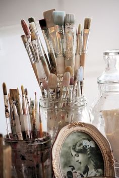 there are many brushes in the glass jar