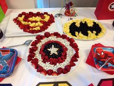 the table is decorated with red, white and blue desserts that look like captain america