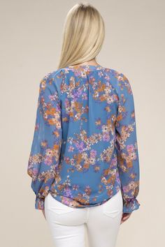 The delicate floral pattern and sheer chiffon fabric make this blouse a true work of art. Its elegant design and lightweight material create a feminine silhouette, making it perfect for any occasion. Floral print pattern Stand collar + V neckline Raglan long-sleeve Non-stretch Lined at bodice, not lined at sleeve Button up closure Fabric: 100% Polyester -Model is 5' 8" and wearing size Small Care instruction: Machine wash cold, tumble dry low Feminine Chiffon Blouse For Spring, Chic Blue Printed Blouse, Fall Chiffon Blouse For Brunch, Chiffon Blouse For Brunch In Fall, Chiffon Blouse With Sheer Sleeves For Spring, Chiffon Blouse With Blouson Sleeves, Flowy Floral Print Blouse, Spring Chiffon Blouson Sleeve Top, Spring Chiffon Top With Blouson Sleeves