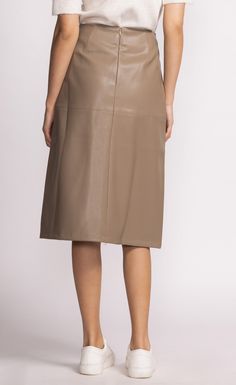 The Peyton Skirt is a chic mid-length faux leather piece that adds a touch of sophistication to any outfit. Style it with a tucked-in blouse and heels for a polished look! Material: 55% PU, 45% Polyester Tapered panel detail Back zip closure Model is wearing XS Sleek Leather Pencil Skirt, Classic Leather Skirt For Fall, Relaxed Knee-length Leather Skirt, Leather Relaxed Fit Lined Skirt, Leather Midi Skirt With Lining, Leather Lined Midi Skirt, Chic Knee-length Skirt For Night Out, Chic Faux Leather Pencil Skirt For Work, Chic Knee-length Pleated Skirt