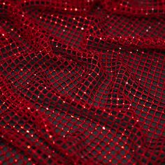 red sequins on black mesh fabric