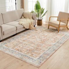 a living room with a couch, chair and rug