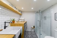 a bathroom with tiled floors and white walls