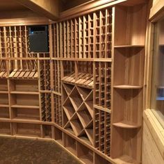 a wine cellar with wooden shelves filled with bottles