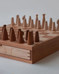 a wooden chess board with several pieces on it