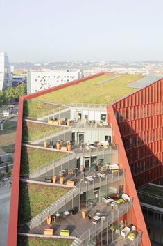 an office building with a green roof in the middle of it's courtyard area