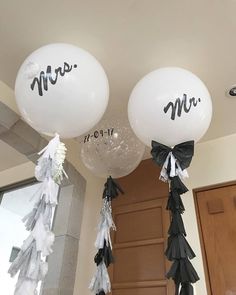 two balloons that say mr and mrs hanging from the ceiling in front of a door