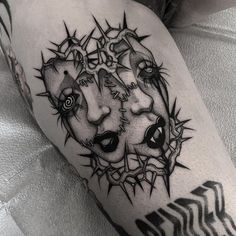 a black and white photo of a tattoo on the leg