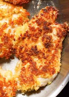 three pieces of fried food in a frying pan