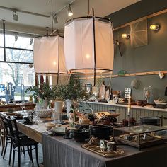 a dining room filled with lots of tables covered in plates and bowls on top of them