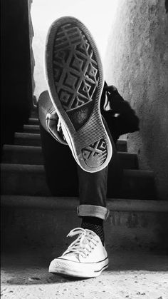 black and white photograph of someone's shoes on the steps