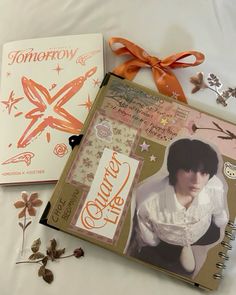 two notebooks with pictures and ribbons on them