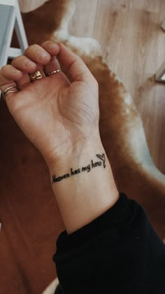 a woman's wrist with a tattoo that reads heaven has my heart on it