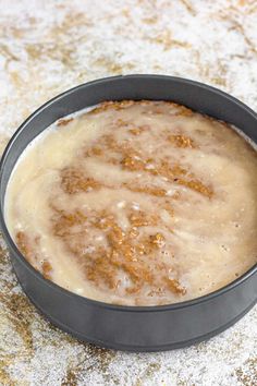 a pan filled with food sitting on top of a table covered in powdered sugar