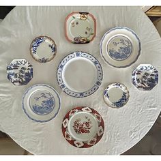 a white table topped with lots of plates