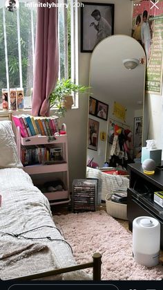 a bedroom with a bed, mirror and bookshelf on the wall next to it