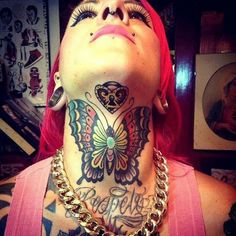 a woman with red hair and tattoos on her neck