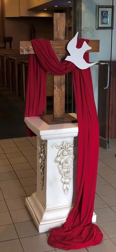 a cross with a red cloth draped over it