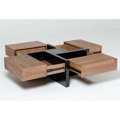 an unusual coffee table with drawers on each side and one drawer open in the middle