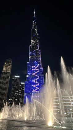 the burj building is lit up in blue and white for new year's eve