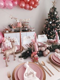 a table set with pink and gold christmas decorations