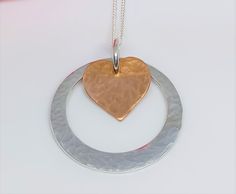 Hammered Copper Heart and Hammered Sterling Silver Washer Hoop Pendant, Copper and Silver Pendant, Copper and Silver Necklace This copper heart has a hammered texture which has been created using traditional silversmithing tools and techniques.  It is layered over a hammered texture sterling silver offset washer.  They are not fixed together, so as to add movement, and fiddleability!  The washer measures approx. 25mm Supplied on an 18 inch sterling silver chain (style may vary) Copper Heart, Layered Necklaces Silver, Silver Chain Style, Hammered Sterling Silver, Copper Necklace, Hammered Copper, Copper Pendants, Hammered Silver, Spiritual Jewelry