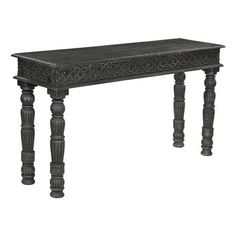 an old wooden table with carved legs and a black finish on the top, against a white background