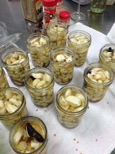 several jars filled with pickles sitting on top of a table