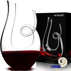 a wine decanter next to a box with a corkscrew in it