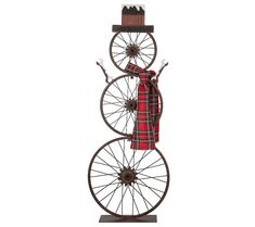 a red and black bicycle with two wheels on it's back, the front wheel is made out of metal