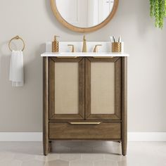 a bathroom vanity with two sinks and a mirror on the wall above it in a neutral color scheme