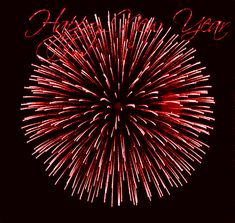 a red firework with the words happy new year written on it and fireworks in the background